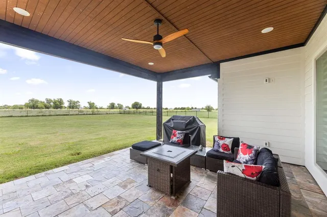 a living room with furniture and garden view