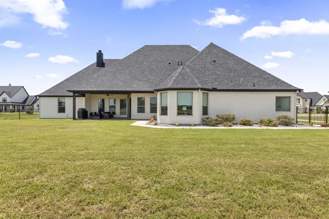 a front view of a house with swimming pool having outdoor seating