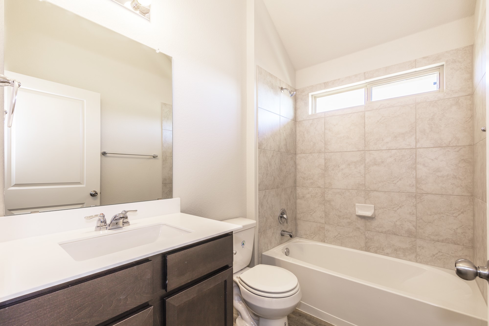 2725 Hopi Path Leander, TX 78641 - Photo 11 of 30 A well-appointed bathroom features a practical vanity and a tub-shower combination.