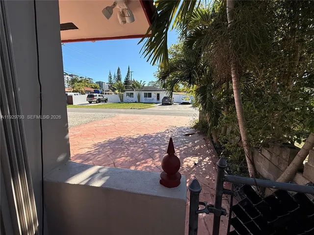 a view of a balcony with yard