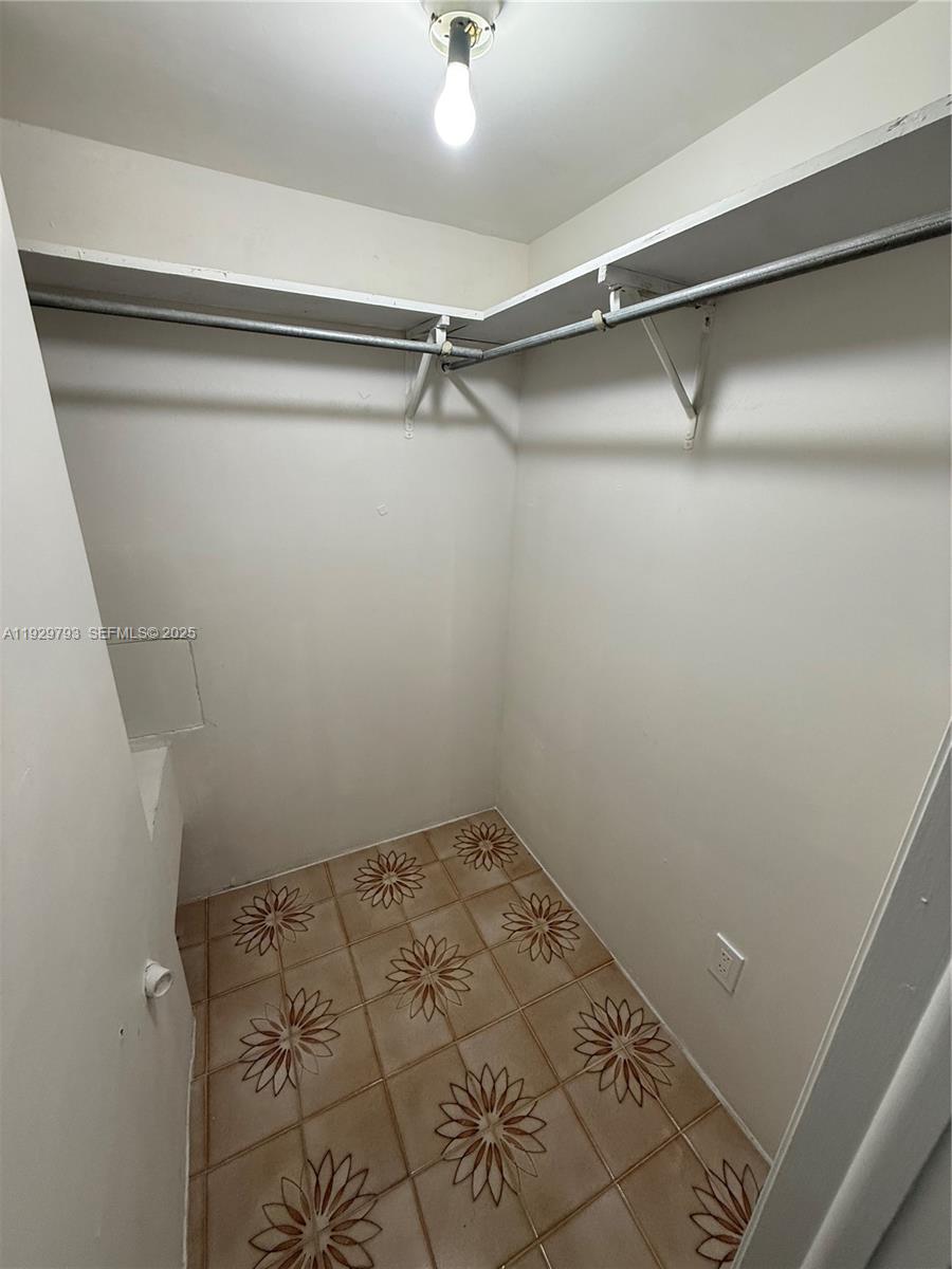 6765 Southwest 19th Street, Unit BACK Miami, FL 33155 - Photo 6 of 7 a view of a room with racks on the wall