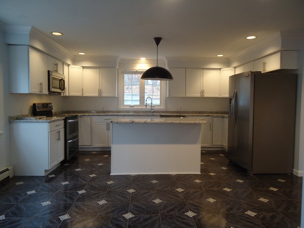 43 Parkland Road Needham, MA 02494 - Photo 11 of 30 a kitchen with kitchen island granite countertop a sink a counter top space and stainless steel appliances