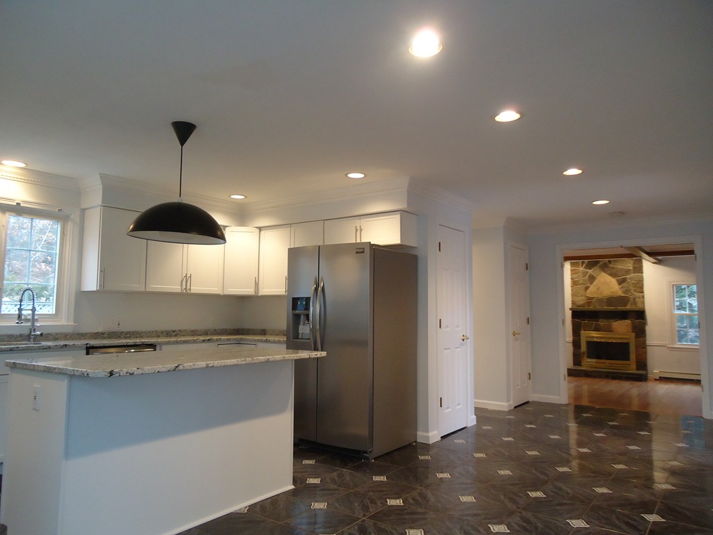 43 Parkland Road Needham, MA 02494 - Photo 13 of 30 a kitchen with stainless steel appliances granite countertop a refrigerator and a stove