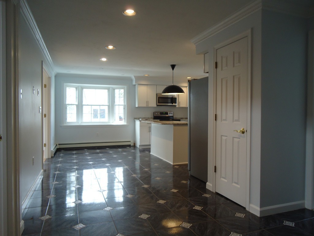43 Parkland Road Needham, MA 02494 - Photo 14 of 30 a view of a kitchen with a sink dishwasher and fireplace