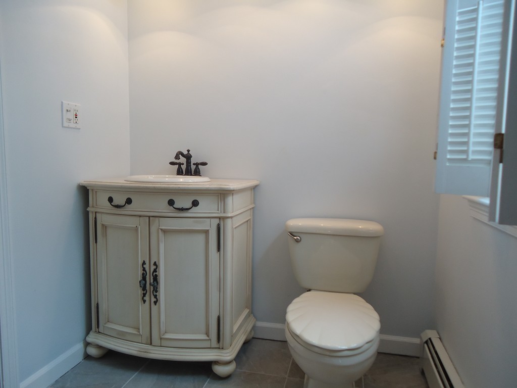 43 Parkland Road Needham, MA 02494 - Photo 16 of 30 a bathroom with a toilet a sink and mirror