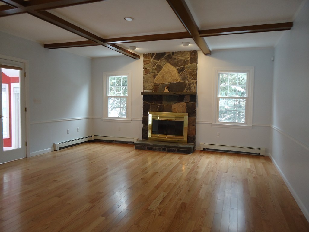 43 Parkland Road Needham, MA 02494 - Photo 18 of 30 an empty room with wooden floor fireplace and windows