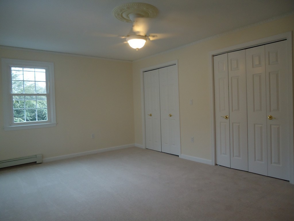 43 Parkland Road Needham, MA 02494 - Photo 24 of 30 an empty room with a ceiling fan and a window