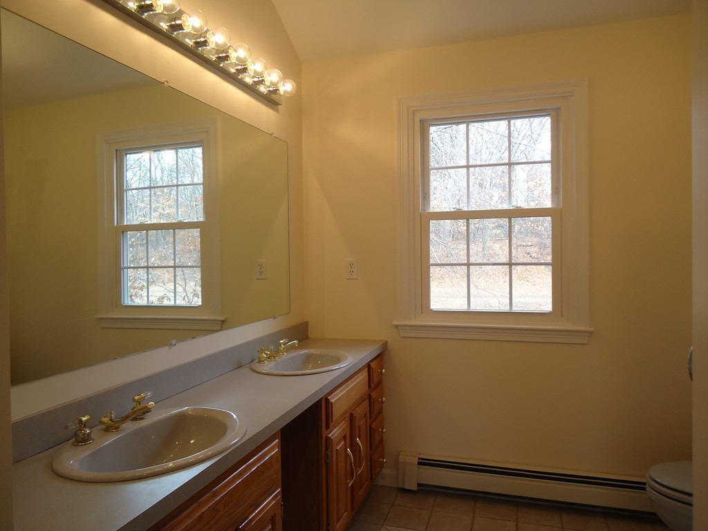 43 Parkland Road Needham, MA 02494 - Photo 27 of 30 a bathroom with a sink and a mirror
