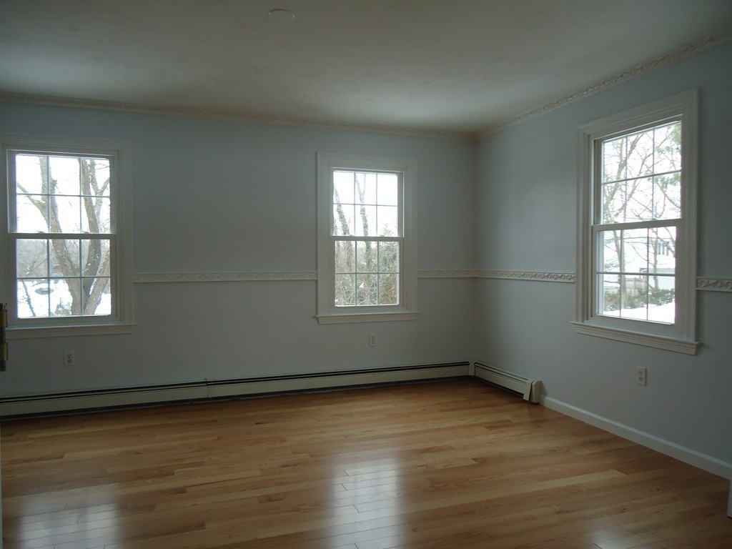 43 Parkland Road Needham, MA 02494 - Photo 8 of 30 an empty room with wooden floor and windows