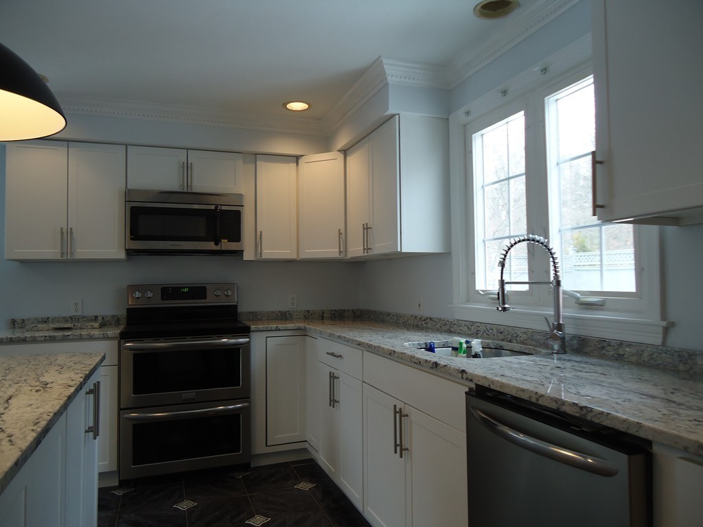43 Parkland Road Needham, MA 02494 - Photo 9 of 30 a kitchen with granite countertop a stove and a sink