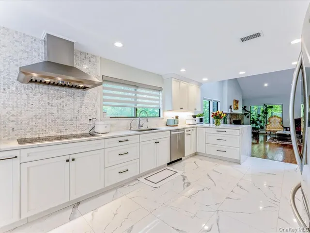 a kitchen with refrigerator and cabinets