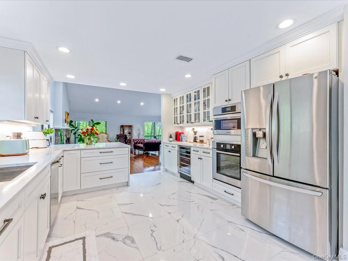 54 Harvard Road, Unit 54 Manhasset, NY 11030 - Photo 13 of 48 a kitchen with refrigerator and cabinets