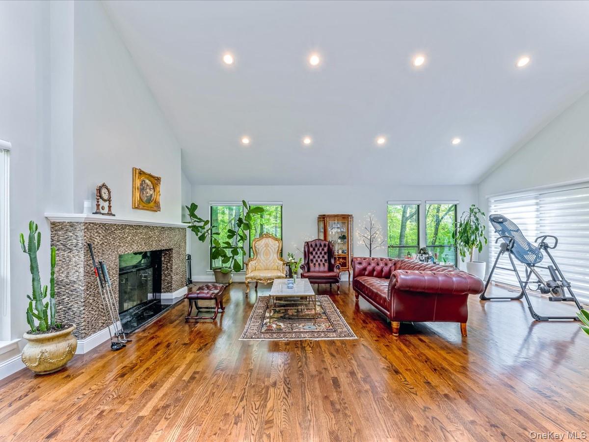 54 Harvard Road, Unit 54 Manhasset, NY 11030 - Photo 14 of 48 a living room with furniture and a fireplace