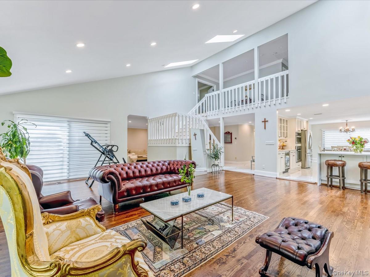 54 Harvard Road, Unit 54 Manhasset, NY 11030 - Photo 15 of 48 a living room with furniture and wooden floor