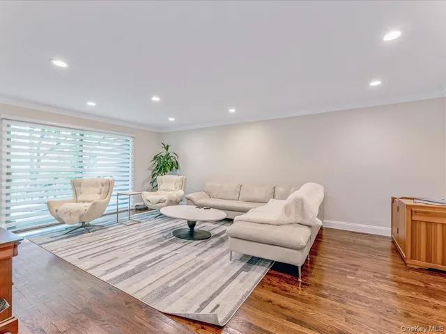 a spacious bedroom with a large bed and a flat screen tv