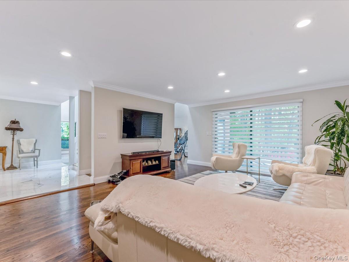 54 Harvard Road, Unit 54 Manhasset, NY 11030 - Photo 18 of 48 a spacious bedroom with a large bed and a flat screen tv