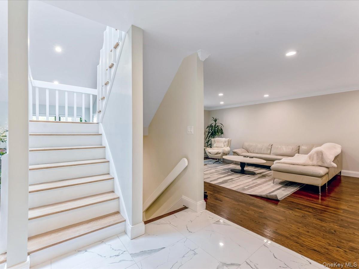 54 Harvard Road, Unit 54 Manhasset, NY 11030 - Photo 19 of 48 a living room with furniture and wooden floor