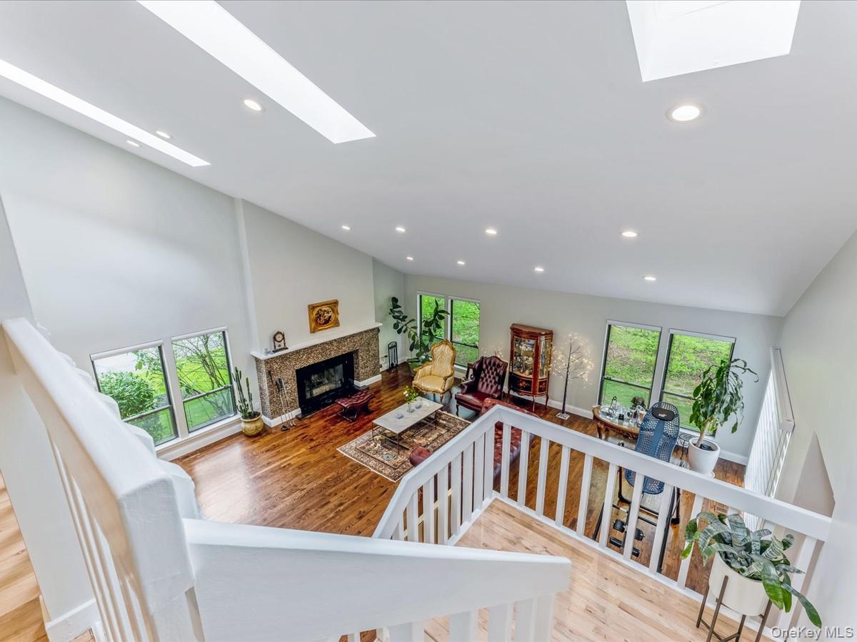 54 Harvard Road, Unit 54 Manhasset, NY 11030 - Photo 20 of 48 a living room with furniture fireplace and flat screen tv