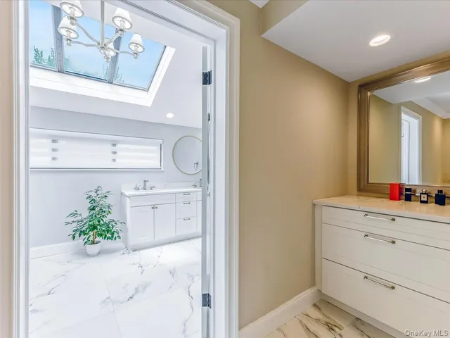 a bathroom with a bathtub sink and mirror