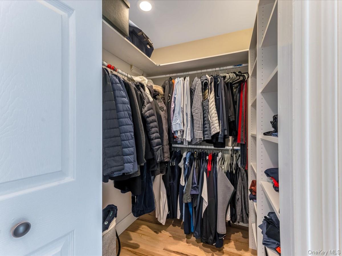 54 Harvard Road, Unit 54 Manhasset, NY 11030 - Photo 28 of 48 a view of walk in closet with clothes