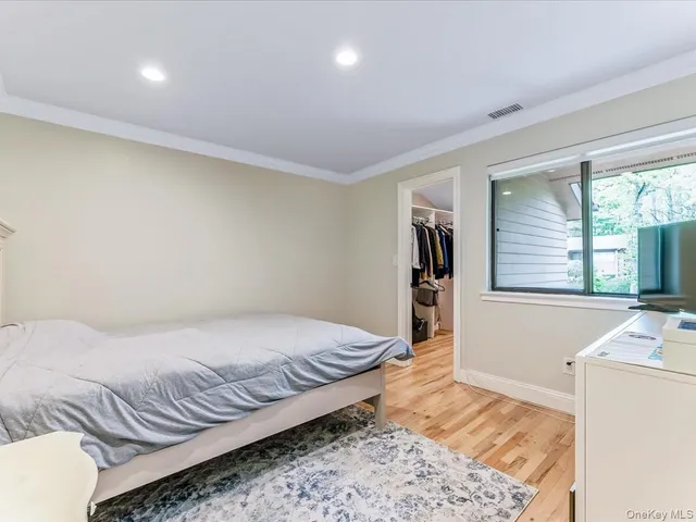 a bedroom with a bed and a television