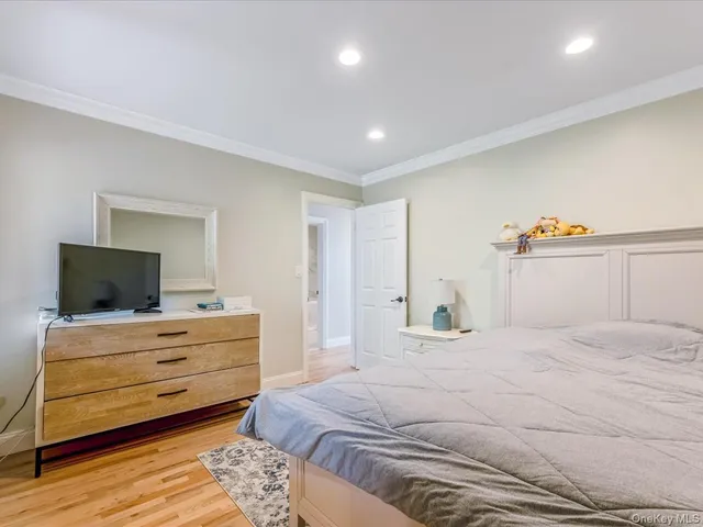 a bedroom with a bed and a desk