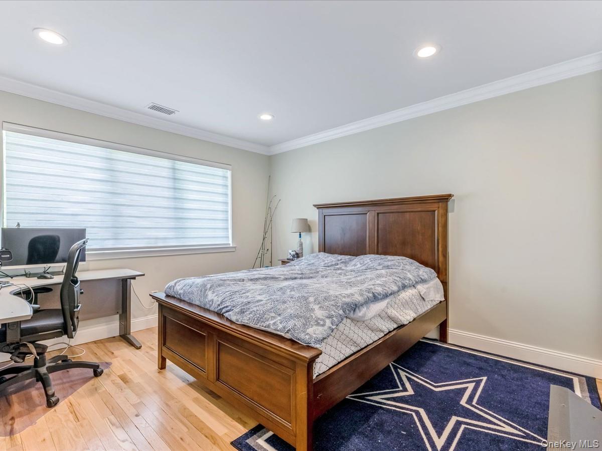 54 Harvard Road, Unit 54 Manhasset, NY 11030 - Photo 31 of 48 a bedroom with a bed and a desk