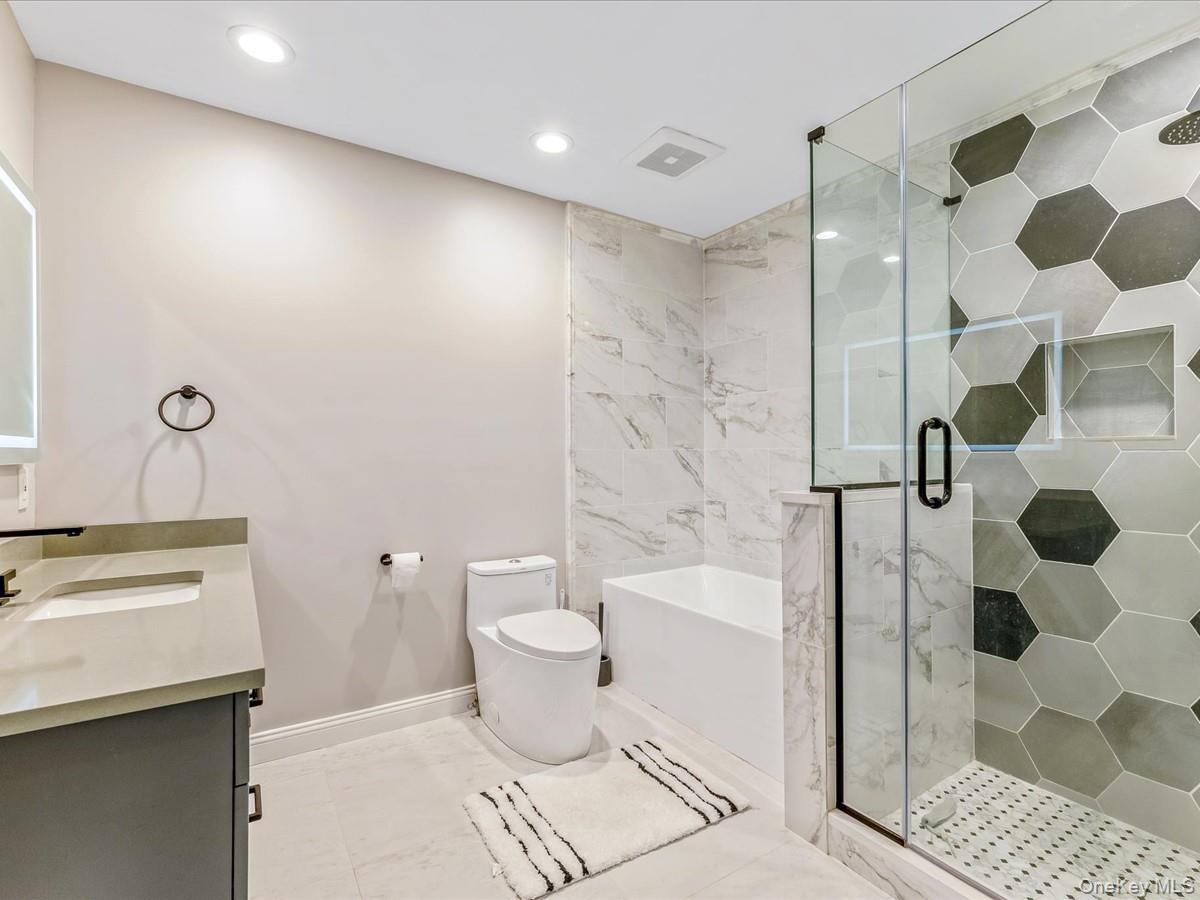 54 Harvard Road, Unit 54 Manhasset, NY 11030 - Photo 32 of 48 a bathroom with a sink toilet and shower