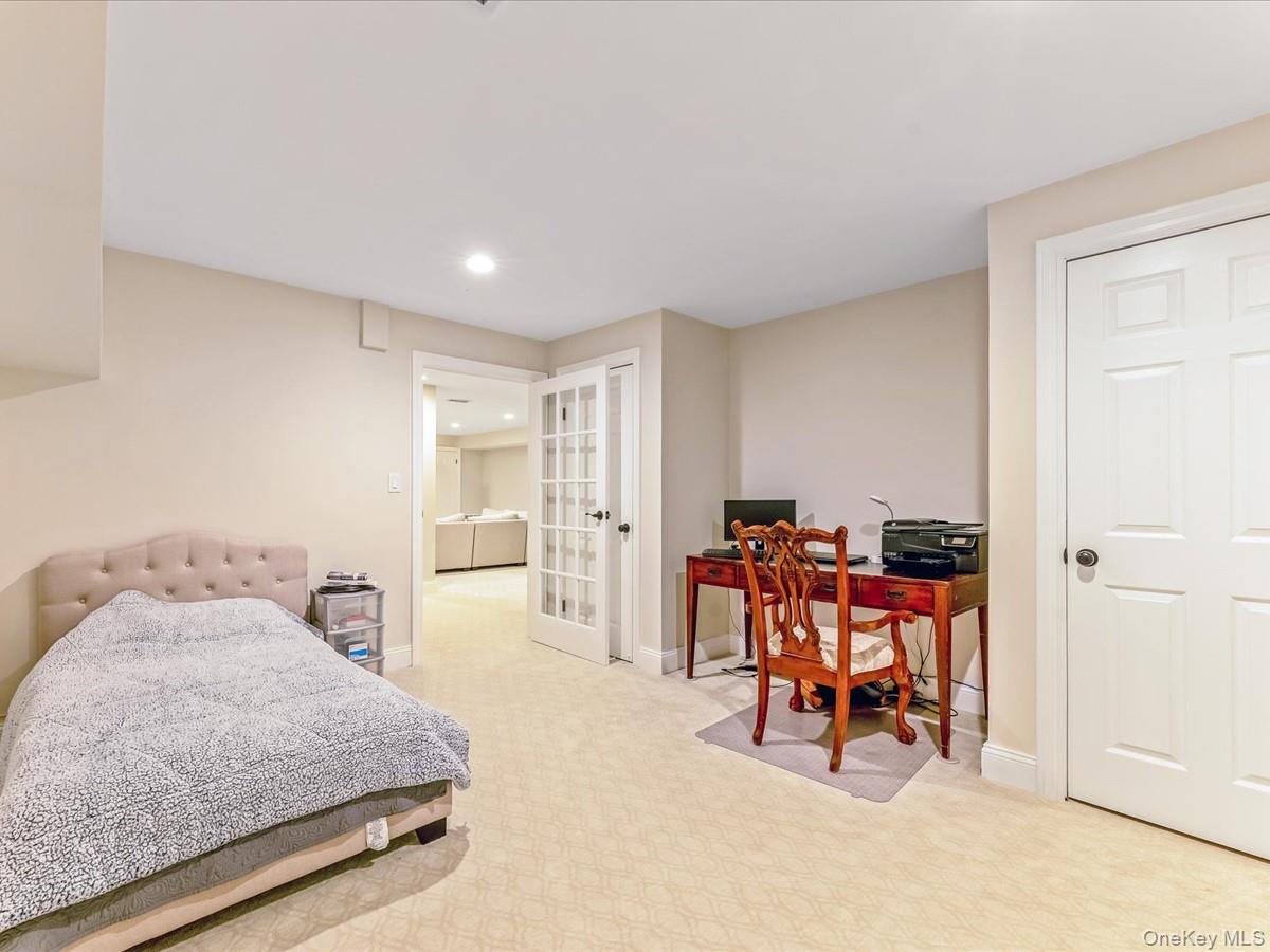 54 Harvard Road, Unit 54 Manhasset, NY 11030 - Photo 38 of 48 a bedroom with furniture and a chair