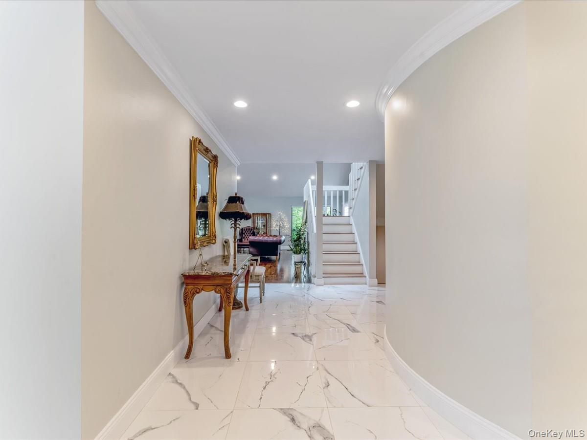 54 Harvard Road, Unit 54 Manhasset, NY 11030 - Photo 6 of 48 a view of a hallway with chairs