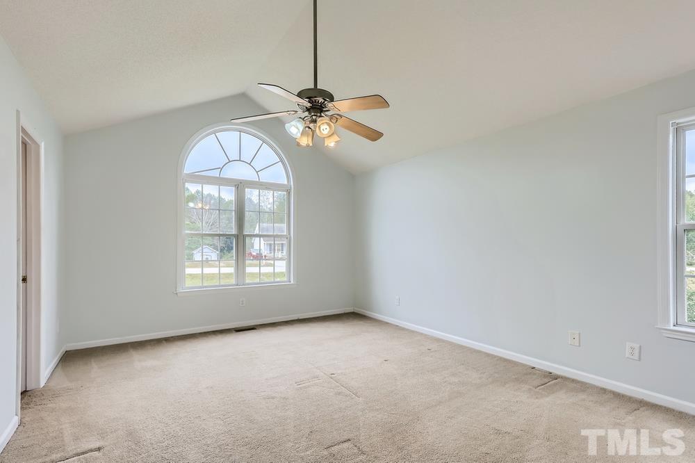 386 Rosa Circle Willow Spring, NC 27592 - Photo 12 of 27 a view of a room with windows and chandelier fan
