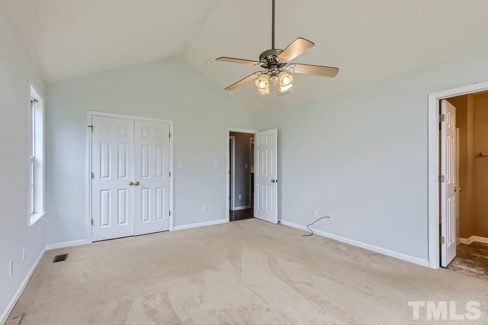 386 Rosa Circle Willow Spring, NC 27592 - Photo 14 of 27 a view of an empty room and chandelier fan