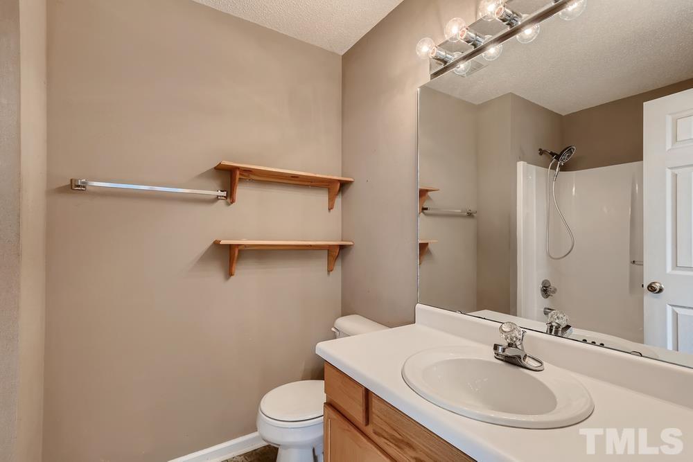 386 Rosa Circle Willow Spring, NC 27592 - Photo 15 of 27 a bathroom with a sink toilet and shower