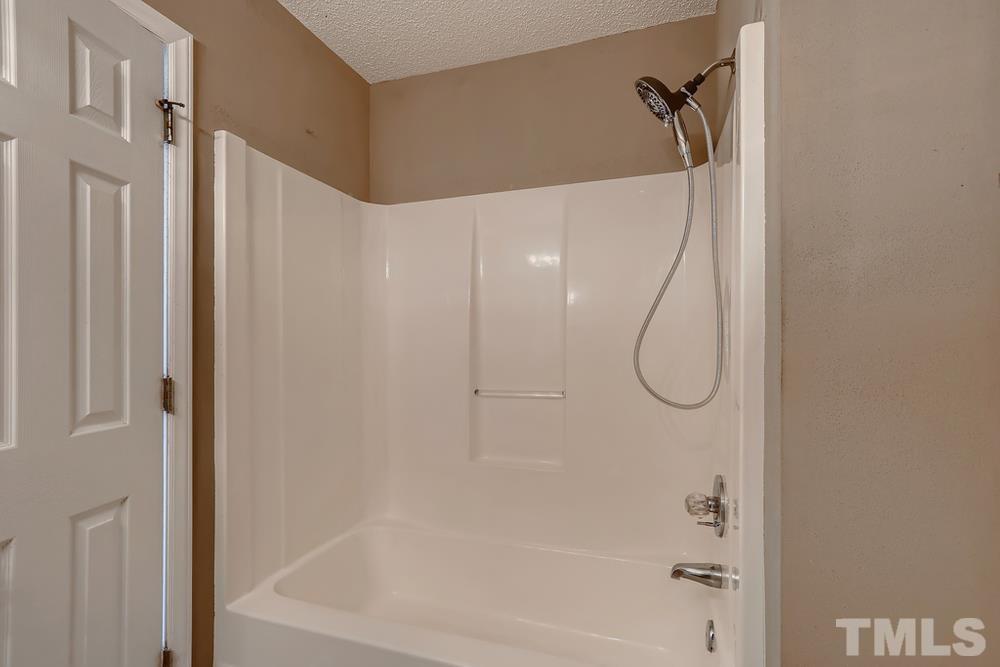 386 Rosa Circle Willow Spring, NC 27592 - Photo 16 of 27 a bathroom with a shower