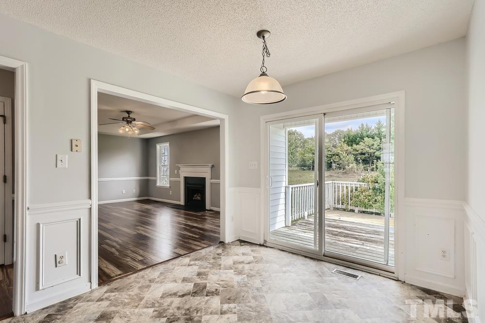 386 Rosa Circle Willow Spring, NC 27592 - Photo 17 of 27 a view of empty room with wooden floor and fan
