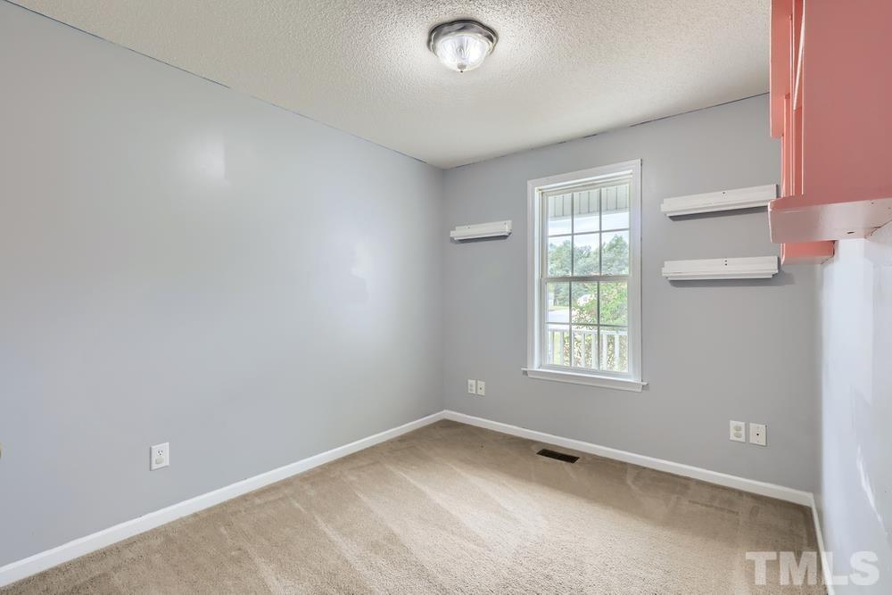 386 Rosa Circle Willow Spring, NC 27592 - Photo 18 of 27 an empty room with a window