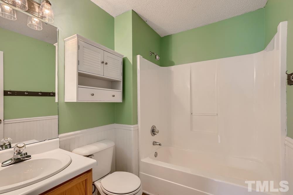386 Rosa Circle Willow Spring, NC 27592 - Photo 19 of 27 a bathroom with a sink toilet and tub