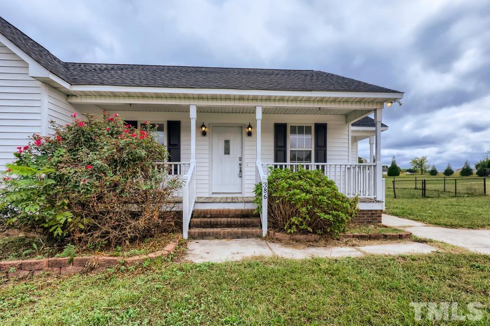 386 Rosa Circle Willow Spring, NC 27592 - Photo 3 of 27 a front view of a house with garden
