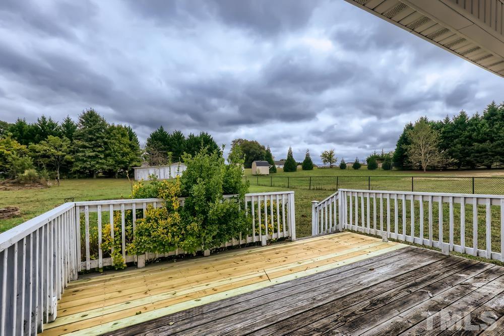 386 Rosa Circle Willow Spring, NC 27592 - Photo 22 of 27 a view of a deck with a yard