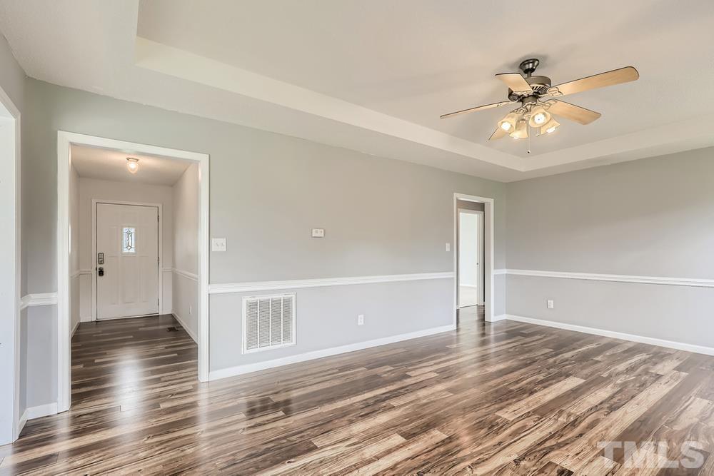 386 Rosa Circle Willow Spring, NC 27592 - Photo 4 of 27 wooden floor in an empty room with a window
