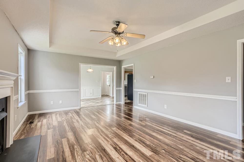 386 Rosa Circle Willow Spring, NC 27592 - Photo 6 of 27 wooden floor in an empty room with a window