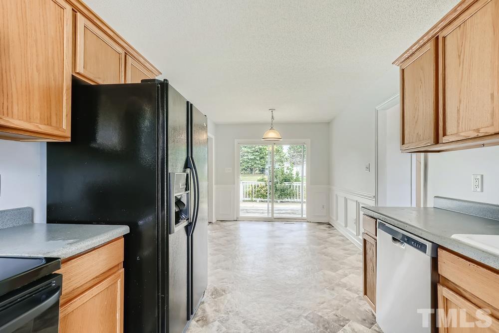 386 Rosa Circle Willow Spring, NC 27592 - Photo 10 of 27 a kitchen with stainless steel appliances granite countertop a refrigerator a sink and a stove