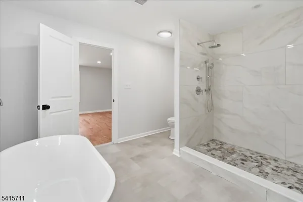 a bathroom with a bathtub and shower