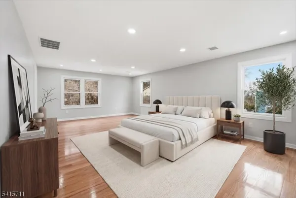 a spacious bedroom with a bed and a couch