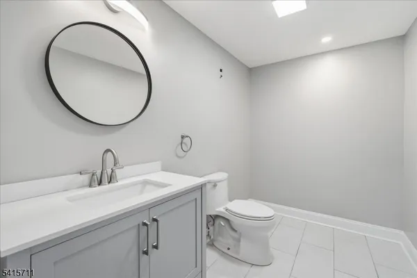 a bathroom with a toilet a sink and a mirror