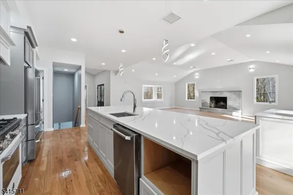 a large kitchen with a center island and stainless steel appliances