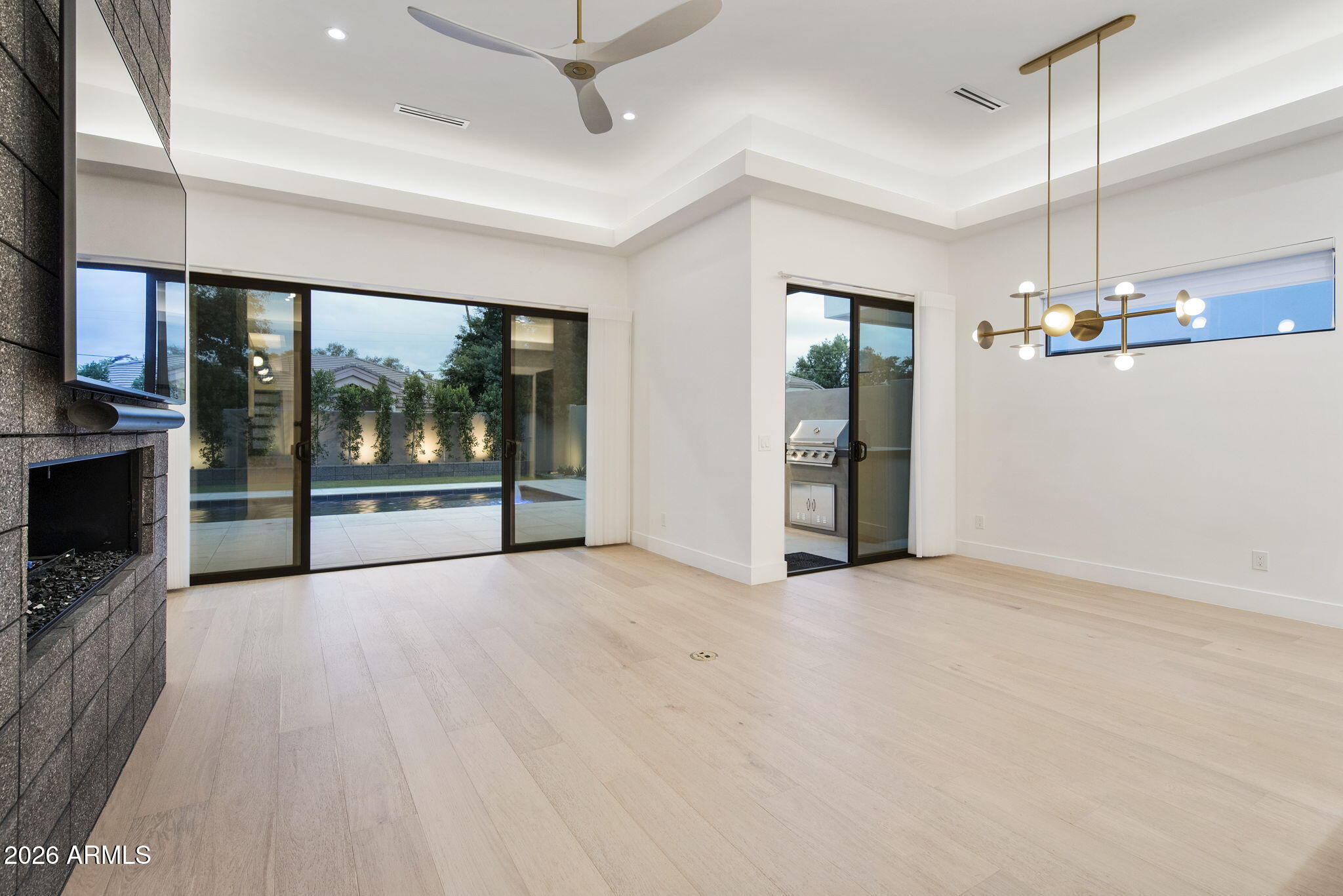 3035 East Coolidge Street Phoenix, AZ 85016 - Photo 11 of 40 an empty room with floor to ceiling window and stainless steel appliances