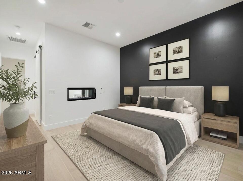 3035 East Coolidge Street Phoenix, AZ 85016 - Photo 12 of 40 a bedroom with a large bed and a potted plant