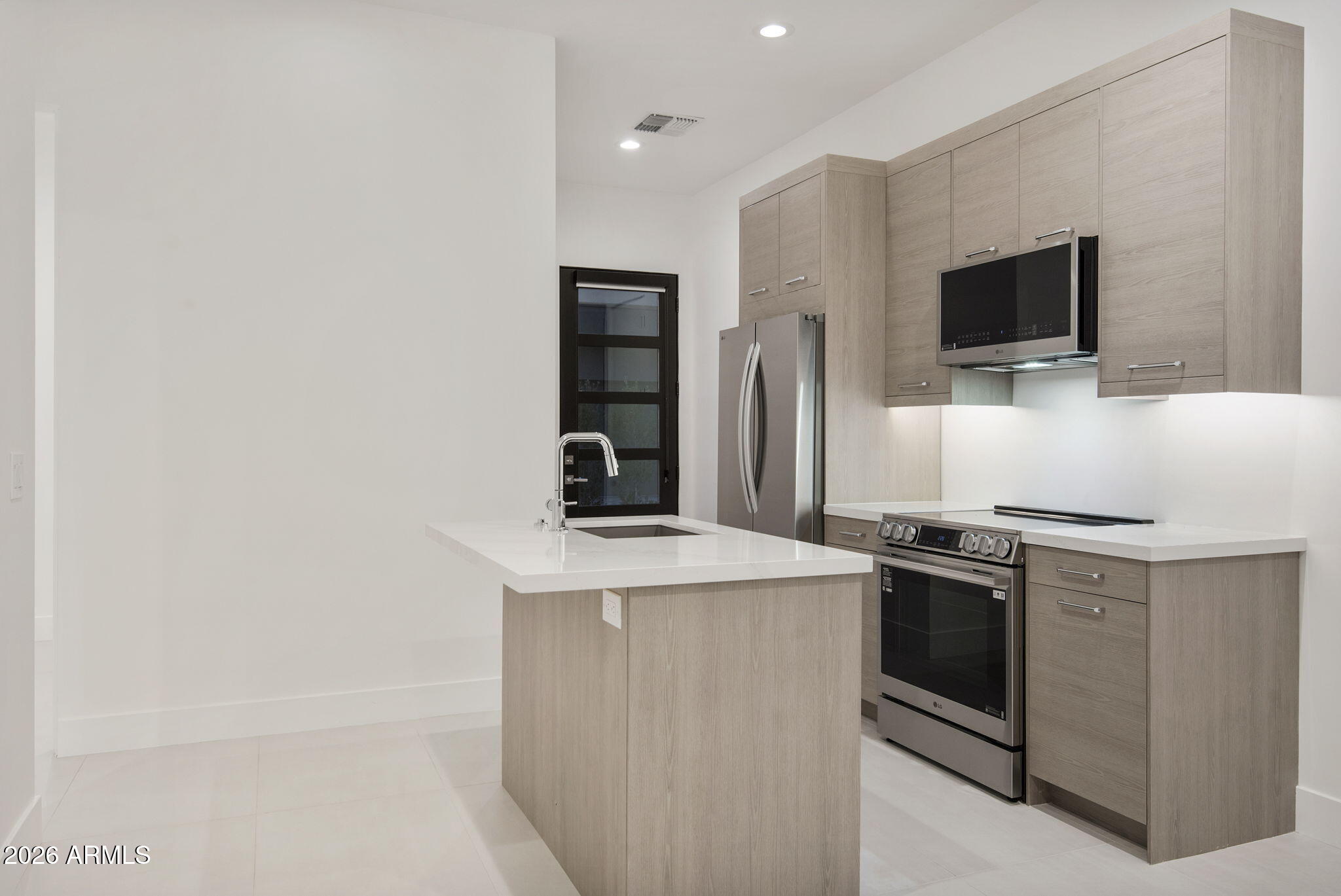 3035 East Coolidge Street Phoenix, AZ 85016 - Photo 30 of 40 a kitchen with stainless steel appliances granite countertop a stove and a microwave