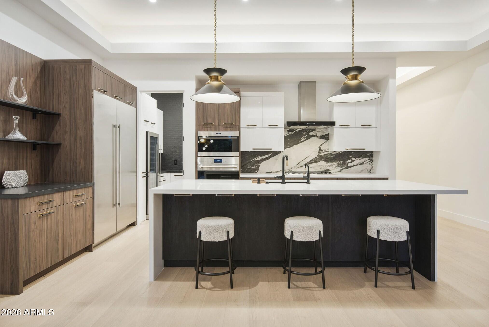 3035 East Coolidge Street Phoenix, AZ 85016 - Photo 8 of 40 a kitchen with stainless steel appliances granite countertop a sink a stove a refrigerator a center island and chairs
